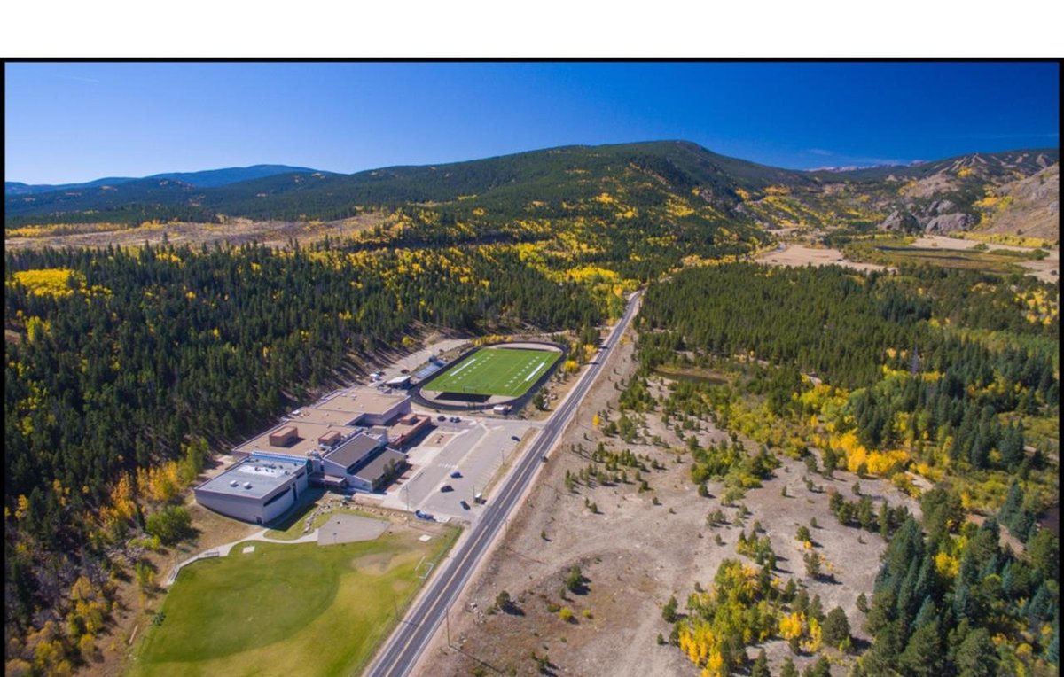 Aerial view looking west over Nederland Middle/High School, the valley, and the Bobcat Ridge property in fall